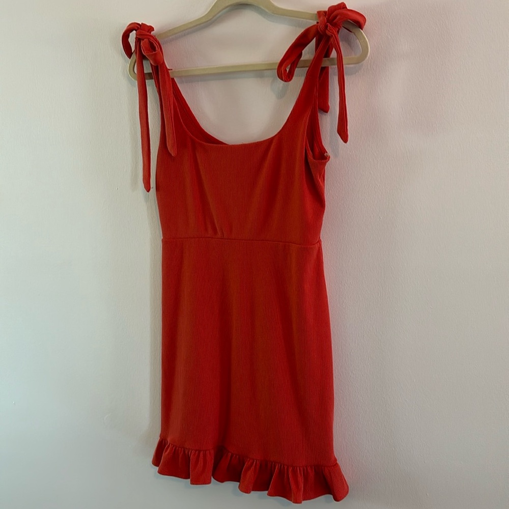 Orangey Red Ribber Dress with Tie Straps and Ruffle Hem. Size Medium.
